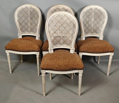 four white painted chairs with brown upholstered cushions