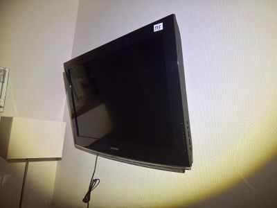 a flat screen tv mounted on a wall in a room