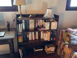 a couch and a book shelf in the corner of a room