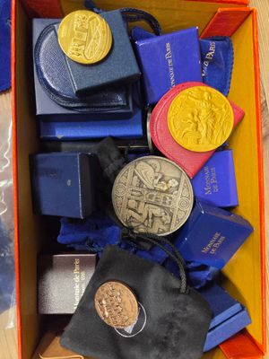 a box full of medals and other items on a table