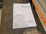 a piece of paper sitting on a table next to a glass of wine