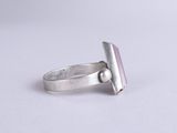 a close up of a silver ring with a pink stone on it