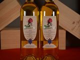 two bottles of wine sitting on a table next to each other