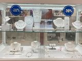a glass display case with a lot of jewelry in it