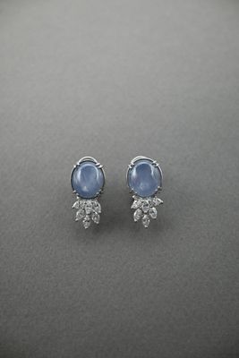 a pair of blue sapphire and diamond stud earrings