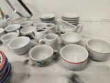 many cups and saucers sitting on a table