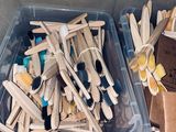 many toothbrushes and toothpaste sticks in a box