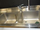 a sink with a faucet and a soap dispenser in it