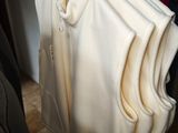 five shirts hanging on a rack in a closet