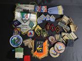 many different types of military badges on a black table