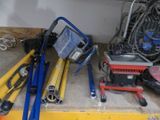 a pile of tools sitting on a shelf in a garage