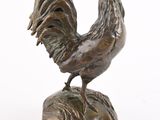 statue of a rooster on a pedestal on a white background