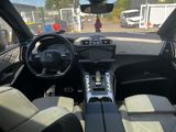 a view of the inside of a car from the driver ' s seat