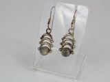a pair of earrings on a clear display stand