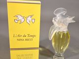 an image of a bottle of perfume next to a box of perfume