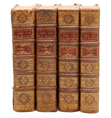 a set of five old books sitting on top of each other