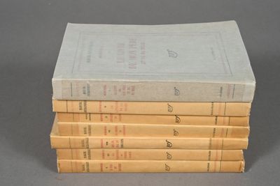 four books stacked on top of each other on a gray surface