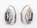 pair of silver and blue stone earrings on a white background