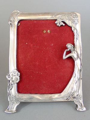 silver plated picture frame with red velvet backing and a lady holding a flower