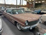 many old cars parked in a parking lot together
