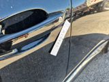 a close up of a car door handle with a sticker on it