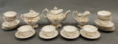 a group of white and gold tea and coffee cups and saucers