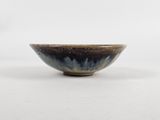 a close up of a small bowl on a white surface