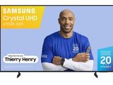 a man standing in front of a tv with the samsung crystal uhd logo on it
