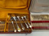 silverware in a wooden case with red handles and handles
