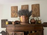 a wooden cabinet with a potted plant on top of it