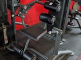 a gym equipment set up in a room with a red wall