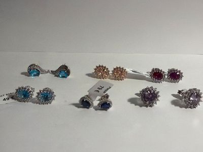 five pairs of rings on a white surface