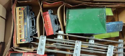 a box full of assorted toy trains and other items