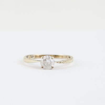 a close up of a diamond ring on a white background