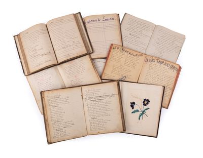 several open books with flowers on them sitting on a white surface