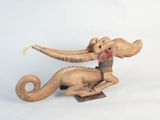 a wooden sculpture of an elephant on a stand