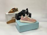 two pairs of shoes are on a box and one is pink and the other is leopard