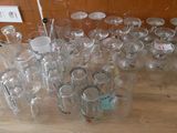 a lot of empty wine glasses sitting on the floor