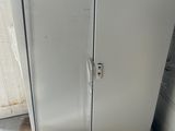 a refrigerator that is sitting in the corner of a room