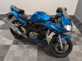 a blue motorcycle that is parked on a checkered floor