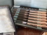 a bunch of knives in a case on the floor
