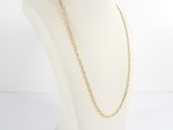 a gold chain necklace on a mannequin head