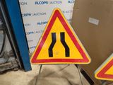 two road signs that are on a metal stand