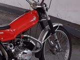 a red motorcycle that is parked in a parking lot