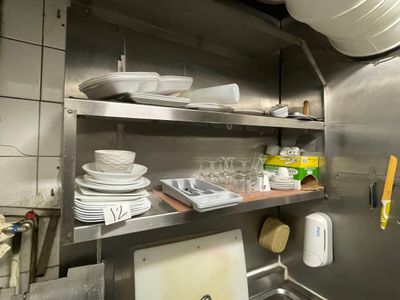 a kitchen with a lot of dishes and dishes on the shelves