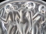 a silver plate with a group of naked women on it