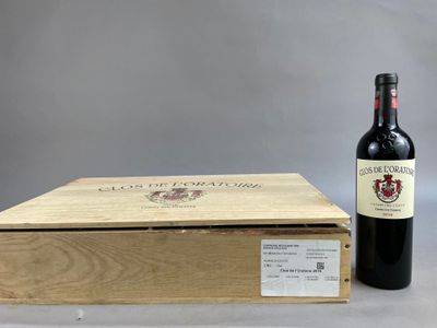 the bottle of wine is next to the box on the table