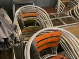 several chairs and umbrellas are lined up in a row in a room