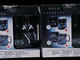 two boxes of black and white coffee cups on display
