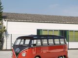 a red and black vw bus parked in front of a building